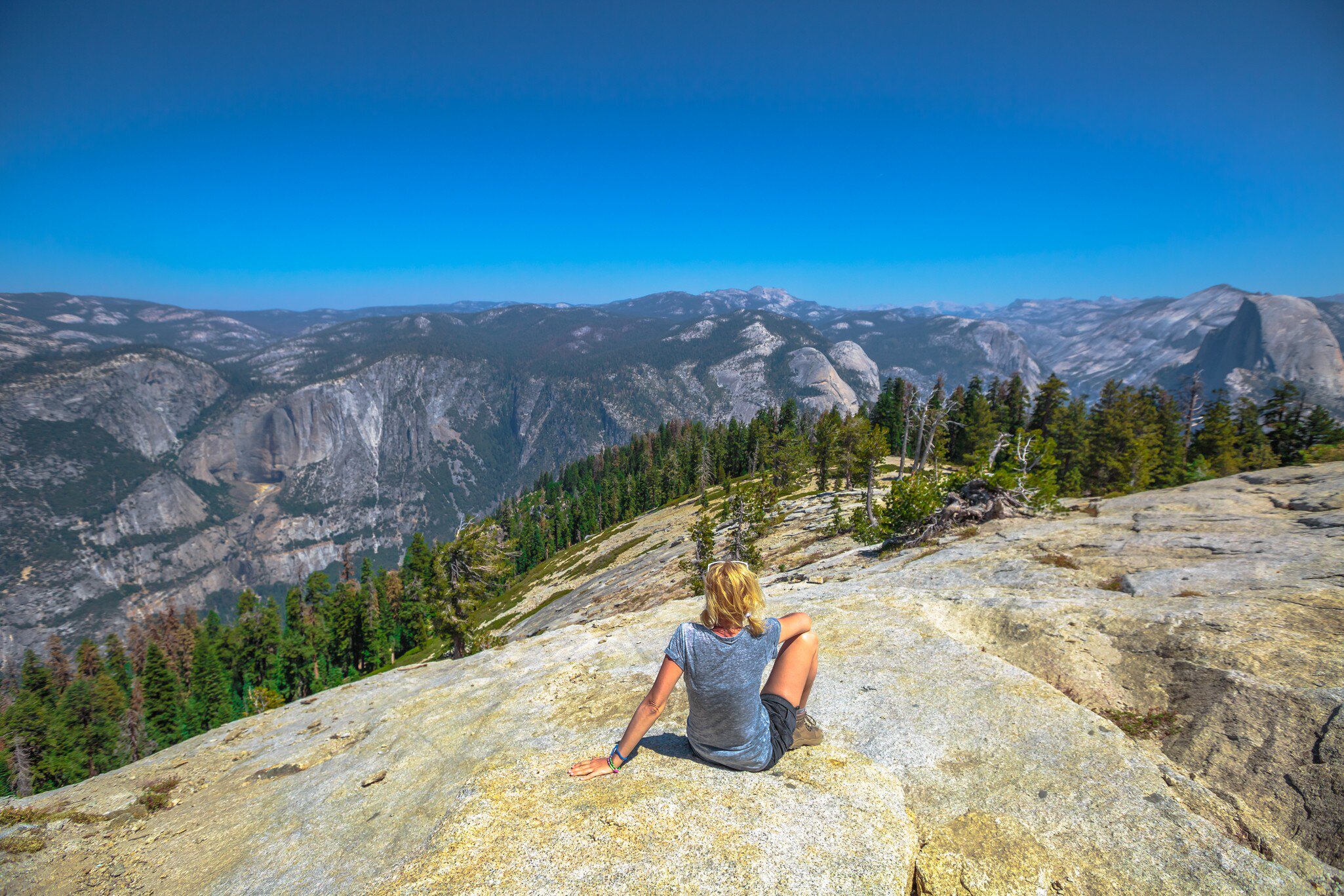 A hiker relaxes atop Sentinel Dome in Yosemite National Park.