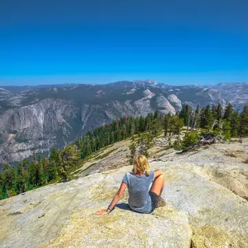 A hiker relaxes atop Sentinel Dome in Yosemite National Park.