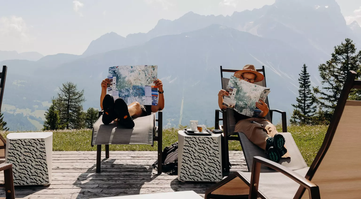 Cortina d'Ampezzo, Italy. June 2025. ..At Col Druscié stop (1778m), people enjoy the sun and relax. The Freccia nel Cielo (Arrow in the Sky) lift, which reaches the top of the Tofane Mountains and has three stops: Col Druscié at 1778m, Ra Valles at 2470m and Tofana di Mezzo at 3244m...Photo by Camilla Ferrari for Lonely Planet