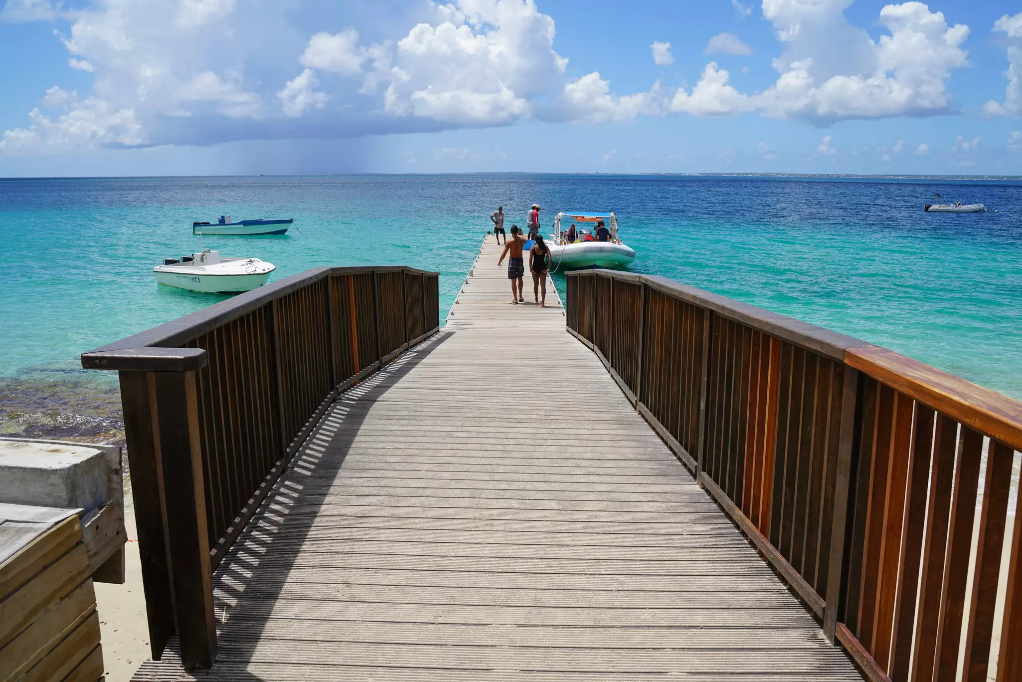 Grand Case, St. Martin USVI Crystal clear tropical Caribbean turquoise ocean water at Friar Bay Beach. Octopus Diving in Grand Case company boat parked at dock in St. Martin.