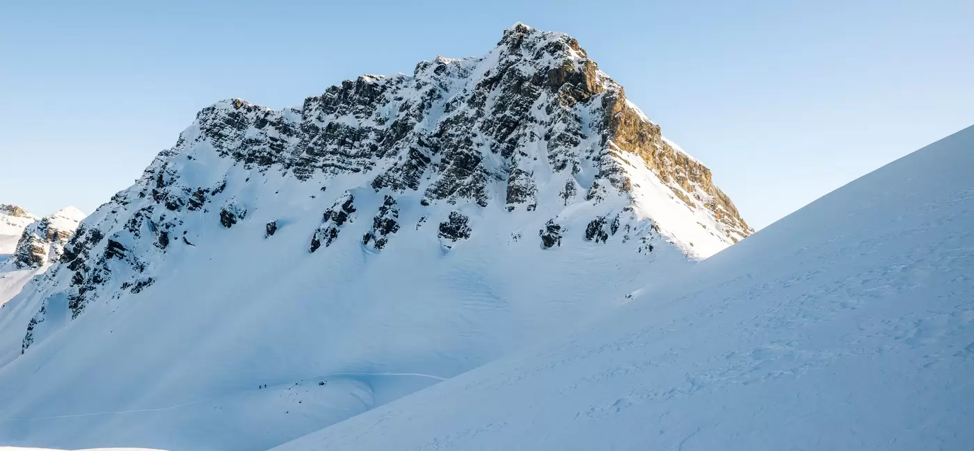 Snow-covered mountain peaks on a bright day in Switzerland