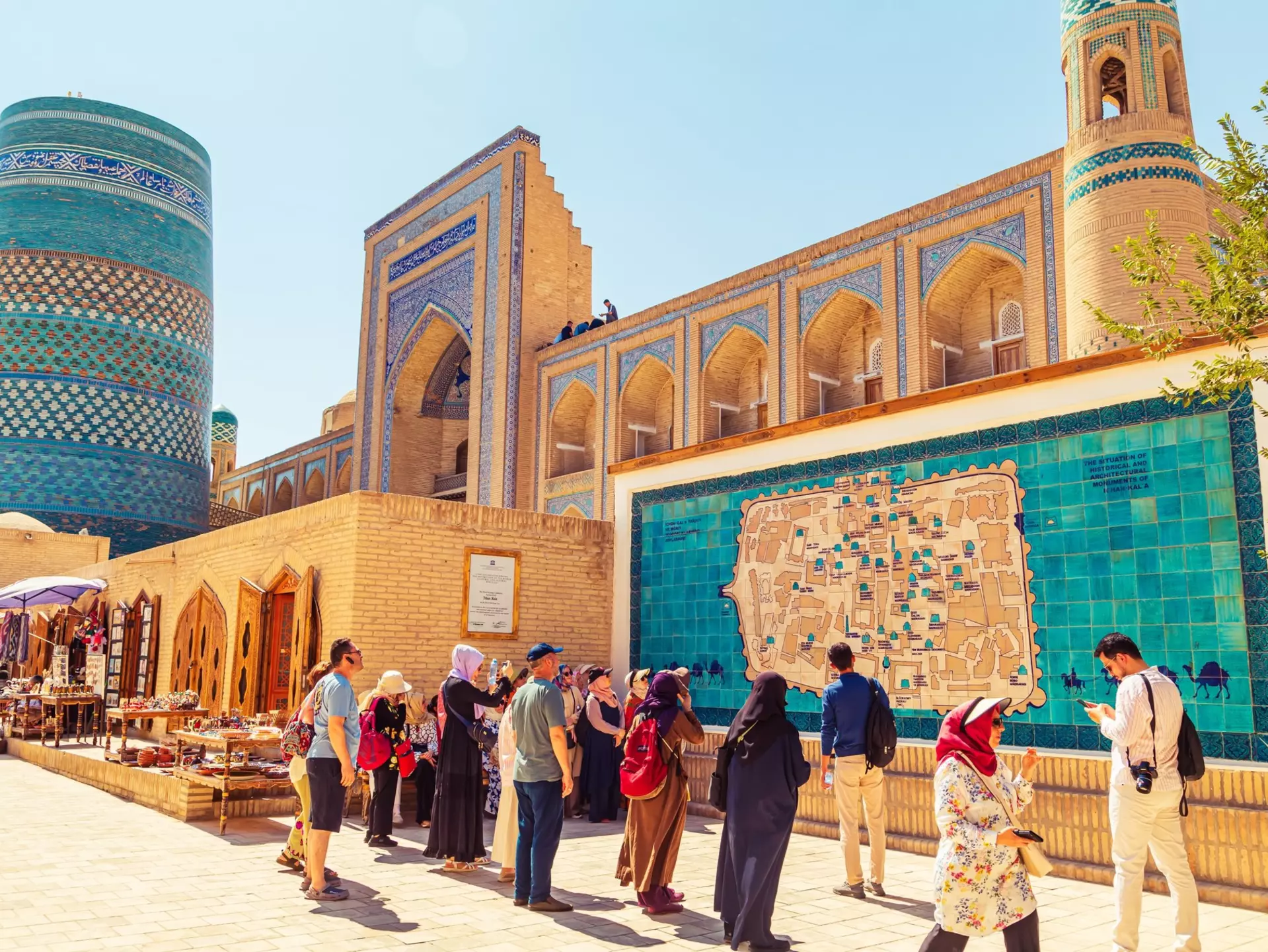 Street bazaar in Itchan Kala at the foot of the Kalta Minar in Khiva, Uzbekistan. Lizavetta/Shutterstock