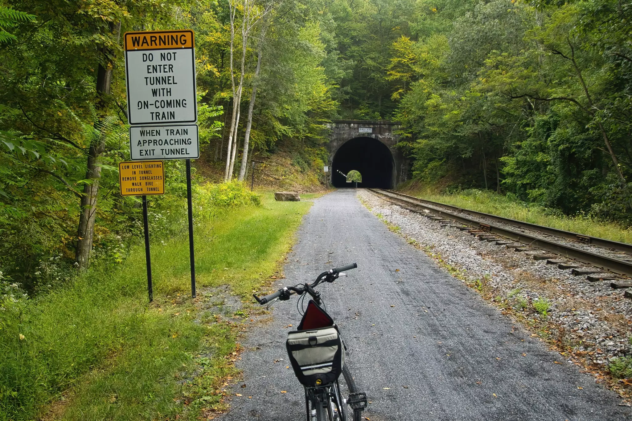 Frostburg, Pennsylvania, USA - Sept. 27 2023: Landscape of a bike parked near a warning sign at the approach to a tunnel on the Great Allegheny Passage recreational trail., License Type: media_digital, Download Time: 2024-08-26T15:57:54.000Z, User: bhealy950, Editorial: true, purchase_order: 65050, job: Lonely Planet Online Editorial, client: Day trips from Pittsburgh, other: Brian Healy