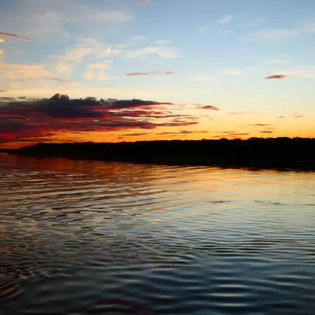 Rippling water under an orange and blue sky in Brazil.