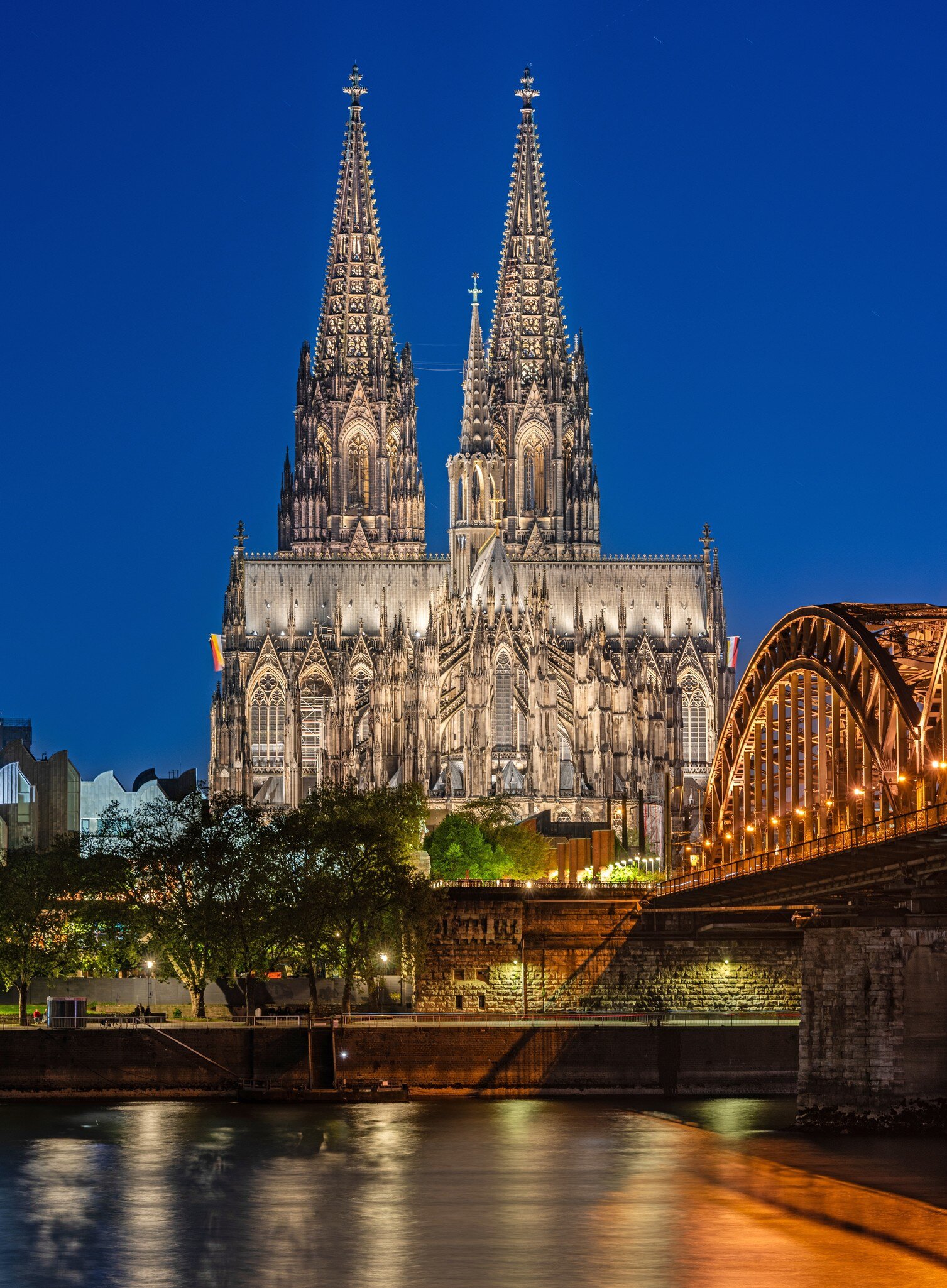 Cologne Cathedral and Hohenzollern Bridge at Blue Hour in Cologne (Köln), Germany.