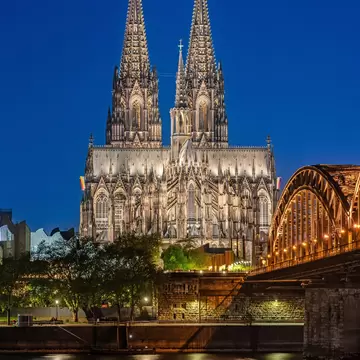 Cologne Cathedral and Hohenzollern Bridge at Blue Hour in Cologne (Köln), Germany.