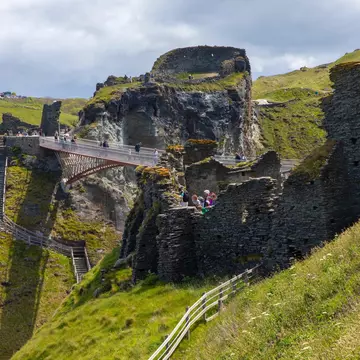 A view of the footbridge and castle ruins at Tintagel Castle in Cornwall, UK.; Shutterstock ID 1988916434; your: Bridget Brown; gl: 65050; netsuite: Online Editorial; full: POI Image Update