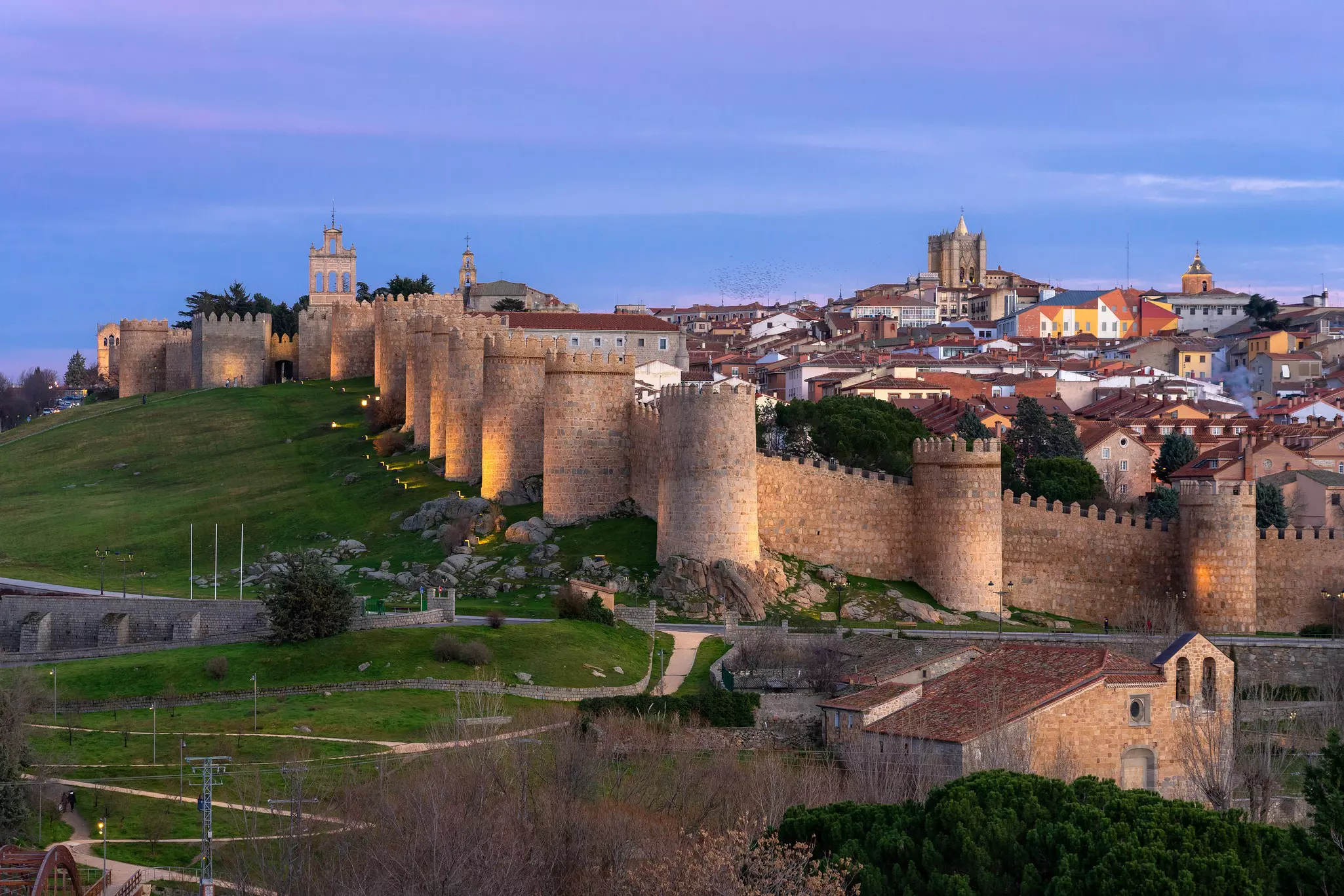 AVILA, SPAIN - DECEMBER 20, 2020: Walls of the city of Avila (World Heritage Site by UNESCO) and Cuatro Postes lookout monument illuminated at night. Castilla y Leon. Spain, License Type: media, Download Time: 2024-10-07T04:09:48.000Z, User: meg3348277, Editorial: true, purchase_order: 56530, job: Global Publishing-WIP, client: Madrid 11, other: Megan Cassidy