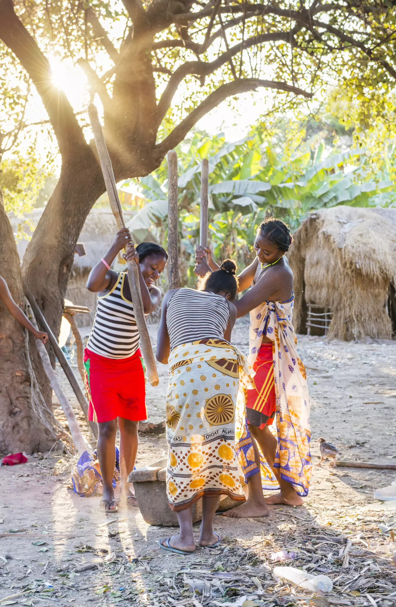 Women pounding rice in a village along the 8a road