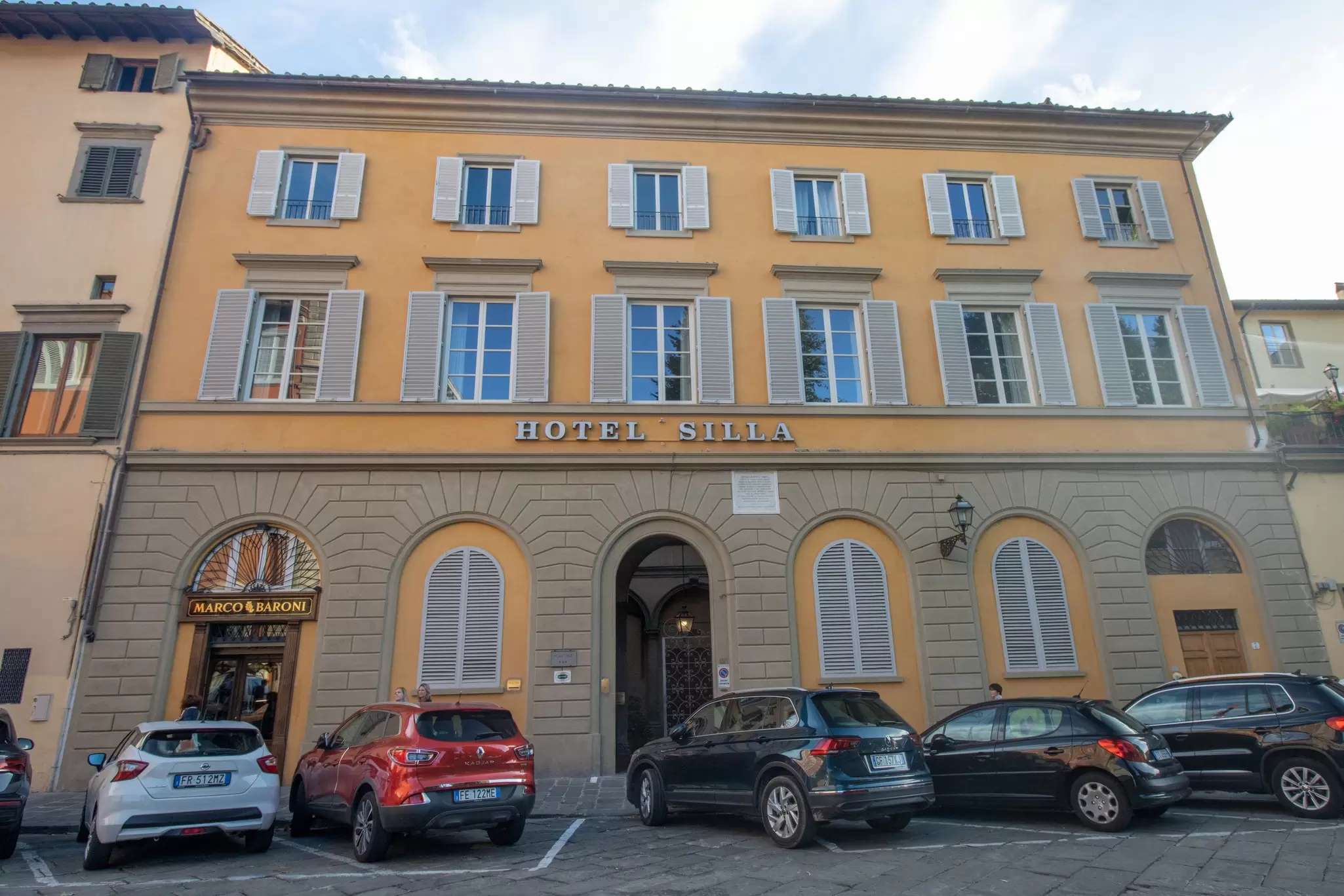 Yellow facade of a historic building with a sign that reads "Hotel Silla"