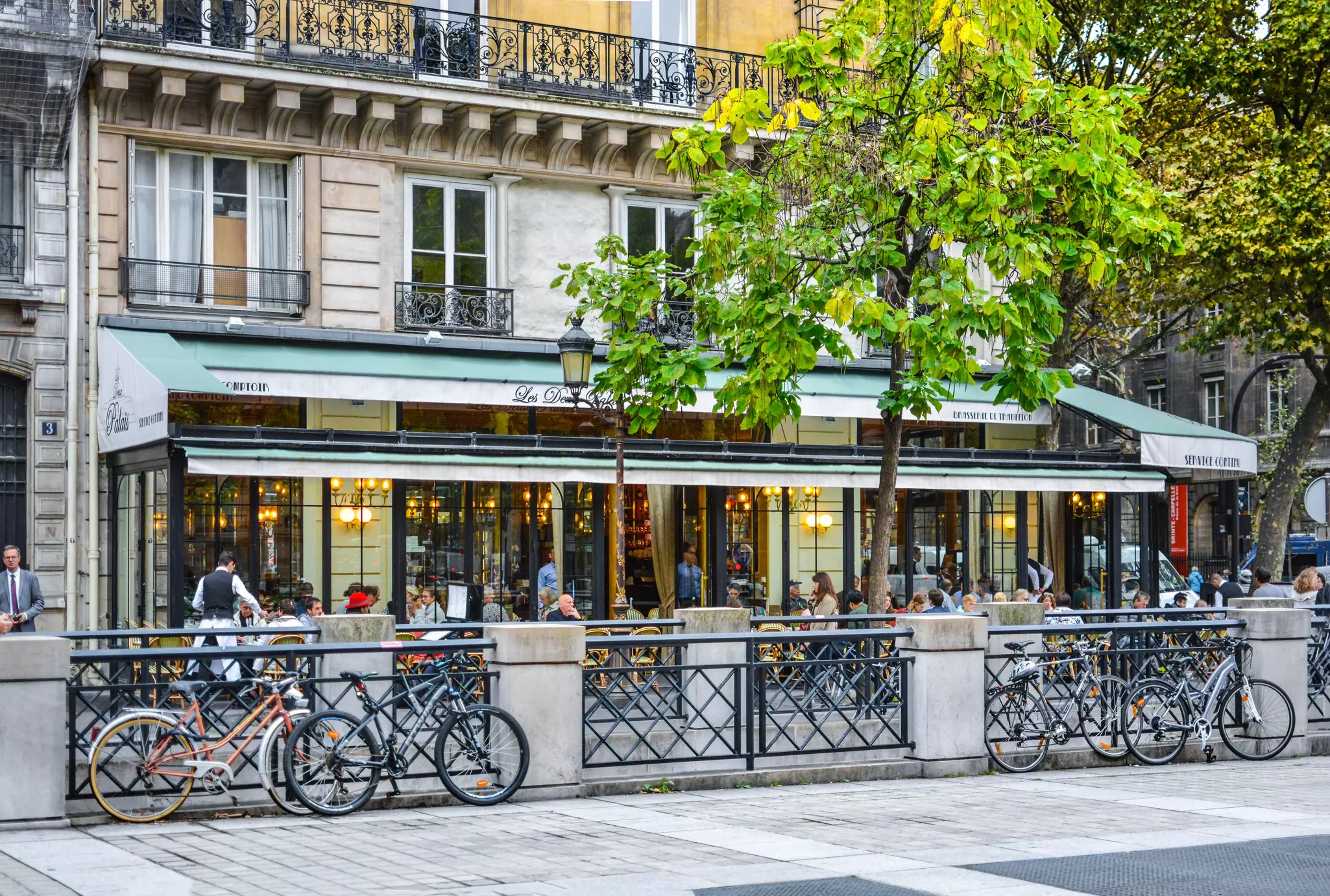 Bikes parked in front of the Brasserie Les Deux Palais on the Ile de la Cite in Paris, France. Kirk Fisher/Shutterstock
