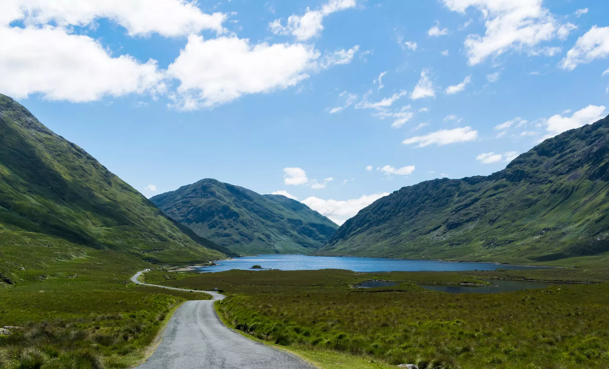 Doolouhgh Valley, County Galway in Ireland. The road pictured passes through Mweelrea Mountain and Sheeffry Hills with the lough or lake laying in between. 