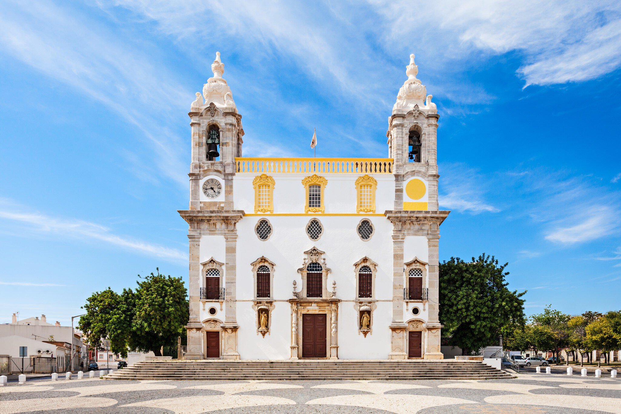 Exterior view of the Igreja de Nossa Senhora do Carmo on a sunny day in Faro, Portugal.