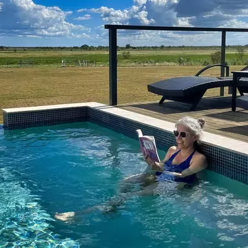 Writer Tasmin Waby relaxes in the pool at the Finniss River Lodge during a visit to Australia's Top End © Tasmin Waby / Lonely Planet