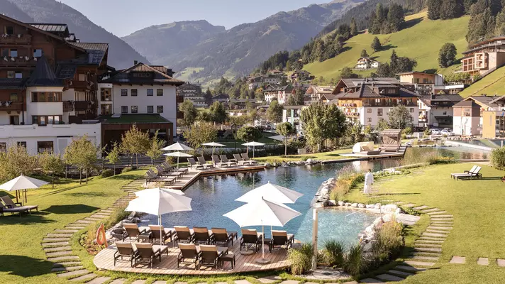 A hotel complex with a pool in a valley.