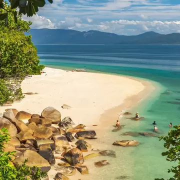 Tropical golden Nudey Beach with turquoise water on Fitzroy Island. It is a continental island southeast of Cairns, Queensland, Australia.