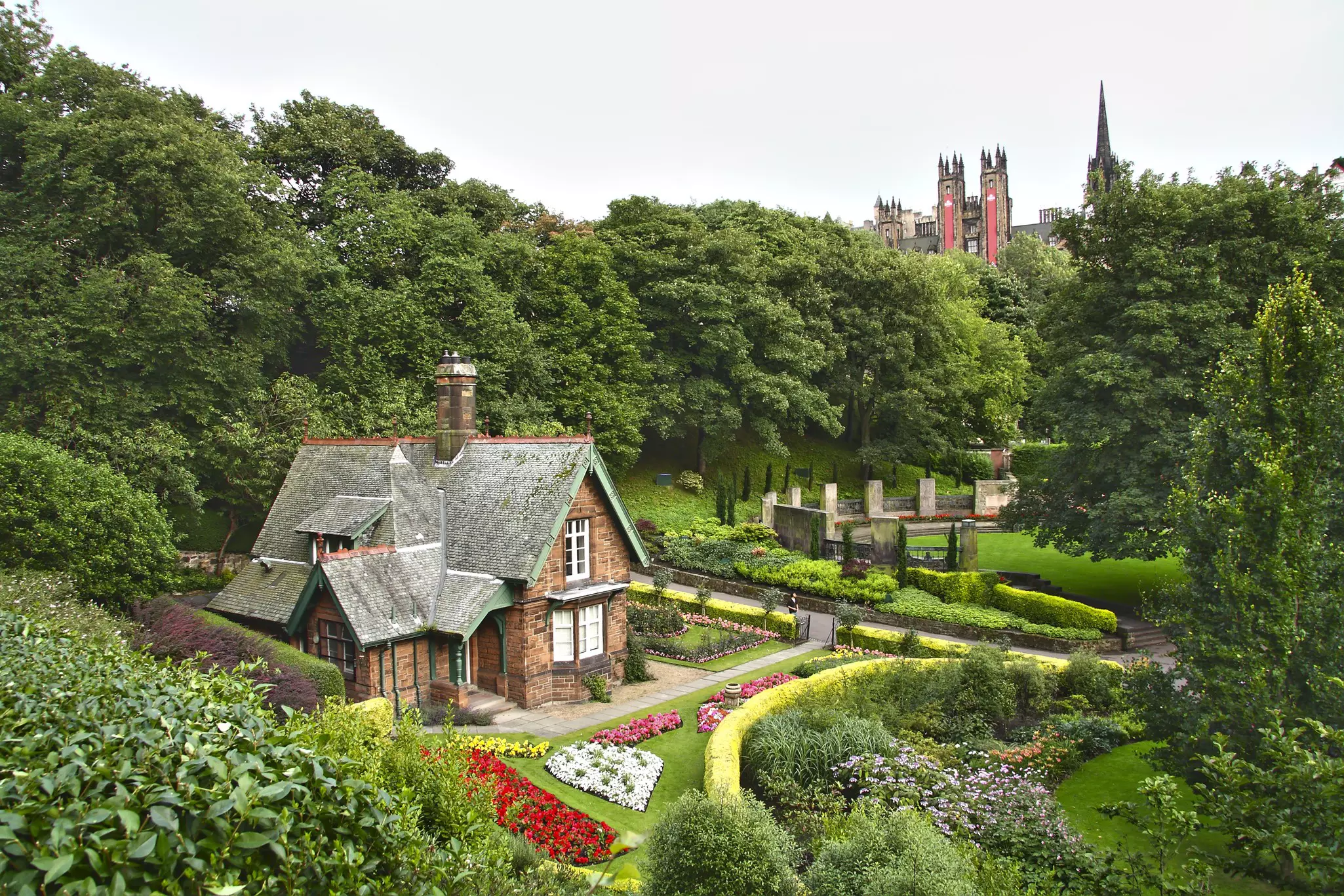 A charming brick house at Princes Street Gardens, with pink, red, yellow and purple flowers