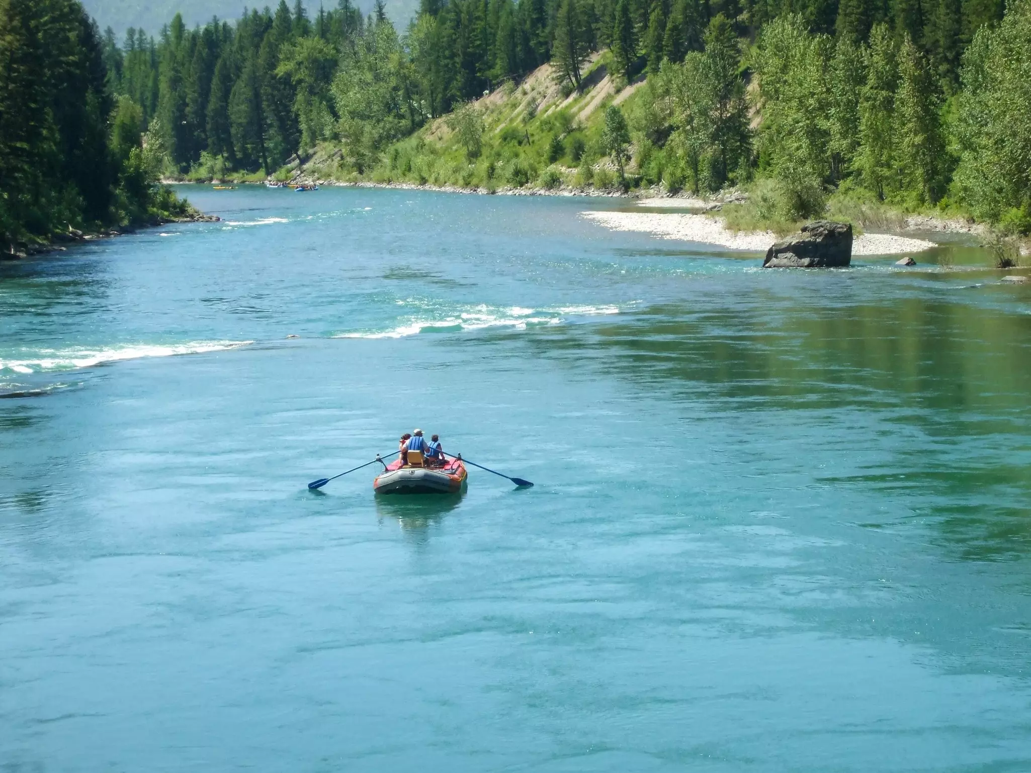 Three people rafting on Flathead River in Montana