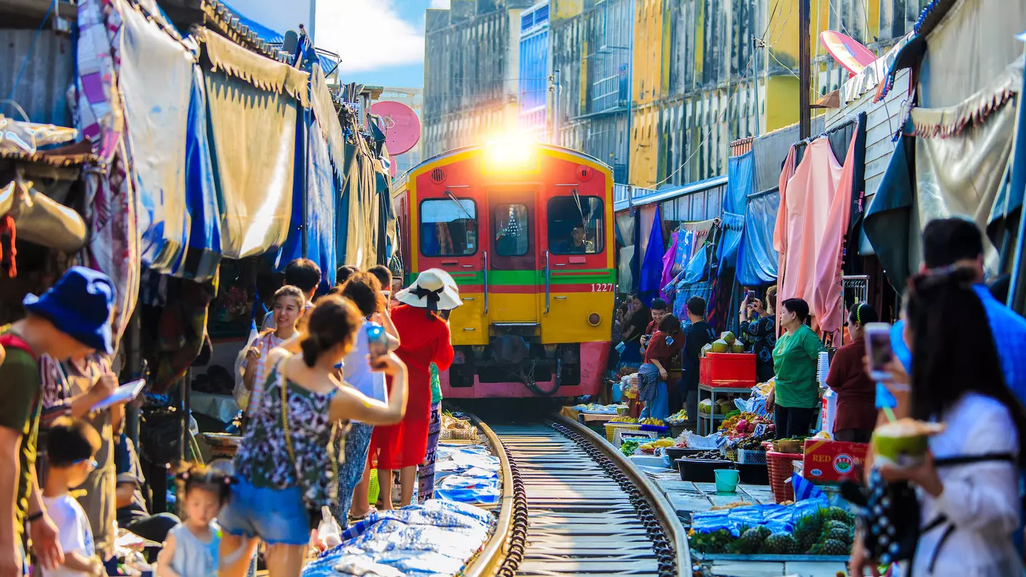 On a day trip from Bangkok to Amphawa, you can take a train that goes through the market at Samut Songkhram – literally © vespaFoto / Shutterstock