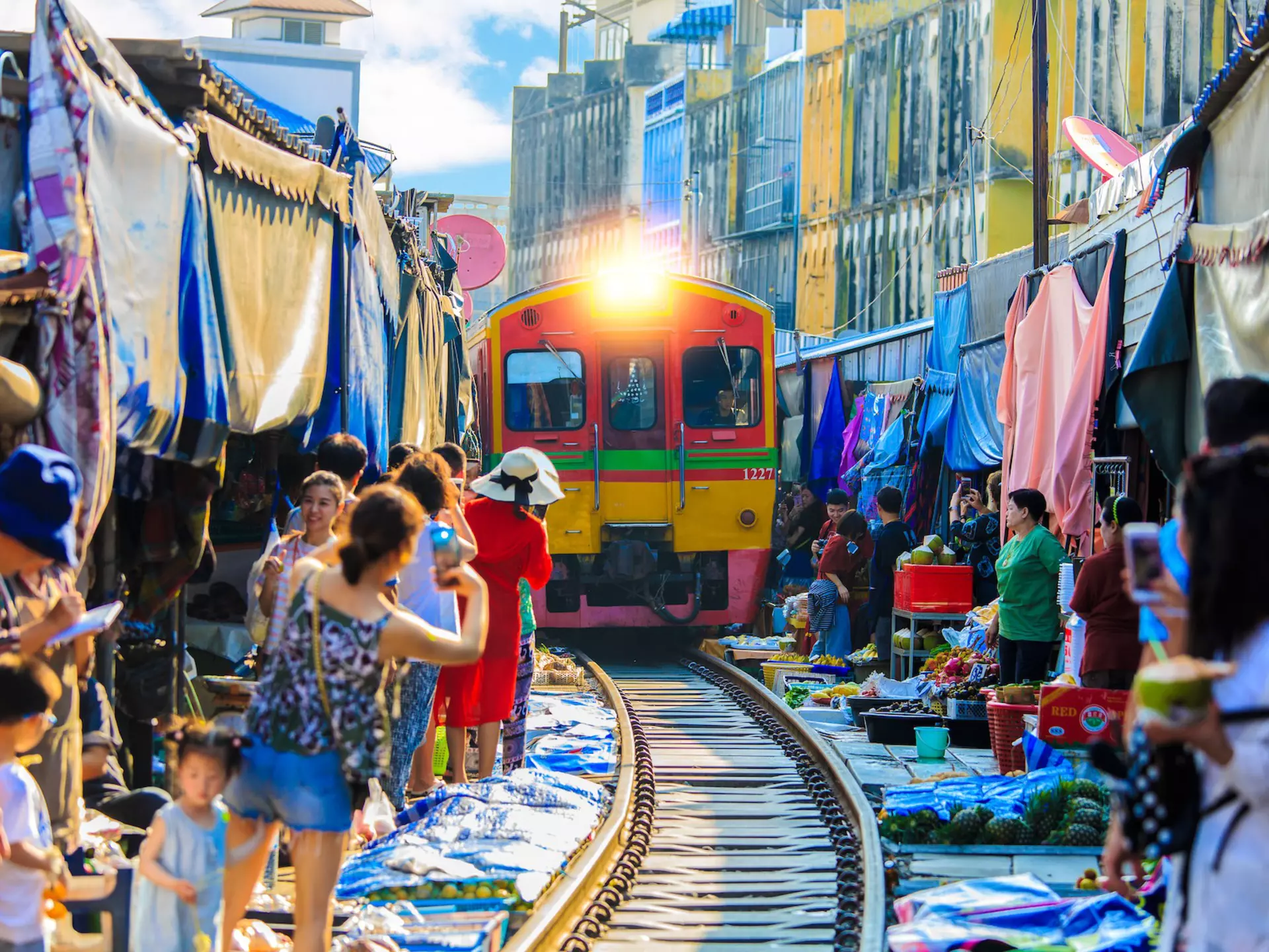On a day trip from Bangkok to Amphawa, you can take a train that goes through the market at Samut Songkhram – literally © vespaFoto / Shutterstock