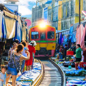 On a day trip from Bangkok to Amphawa, you can take a train that goes through the market at Samut Songkhram – literally © vespaFoto / Shutterstock