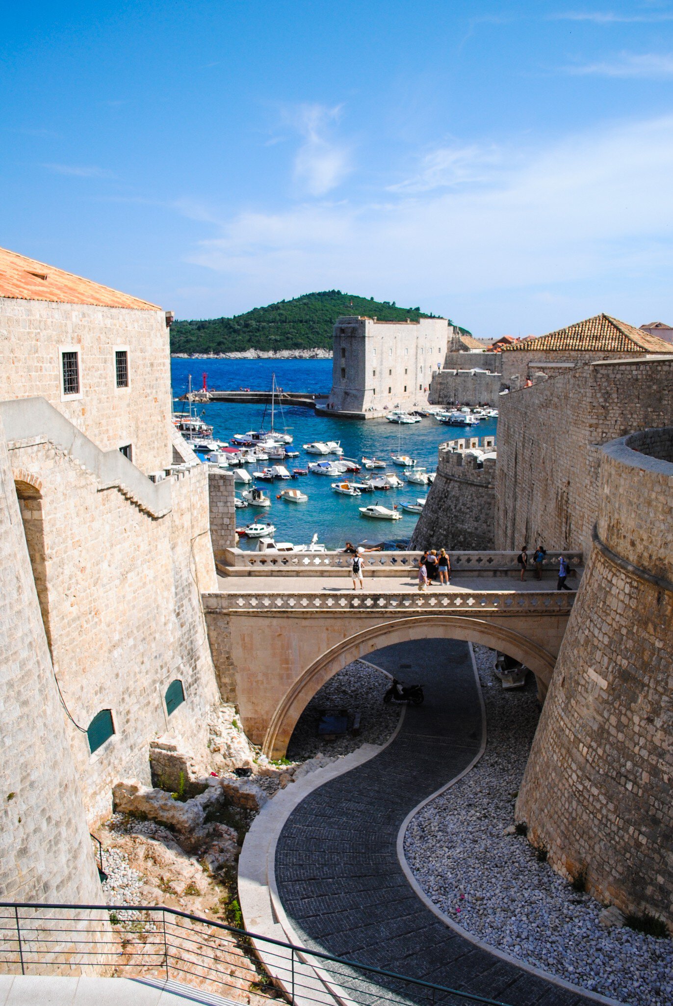 Tourists walk along Dubrovnik's ancient castle, Croatia.