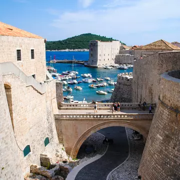 Tourists walk along Dubrovnik's ancient castle, Croatia.