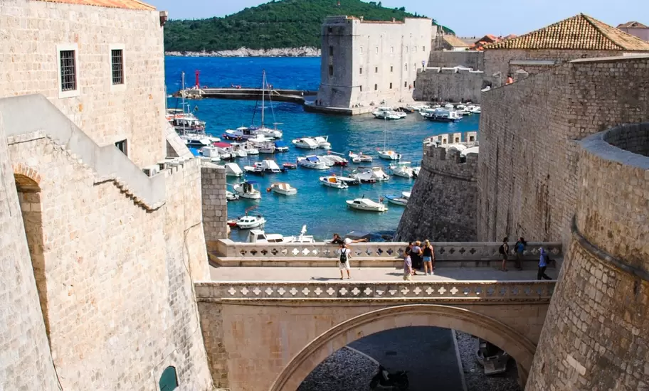 Tourists walk along Dubrovnik's ancient castle, Croatia.