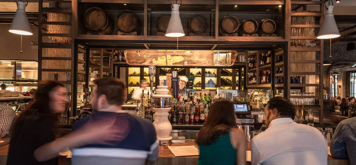 People sitting at the bar at Monteverde in Chicago.
