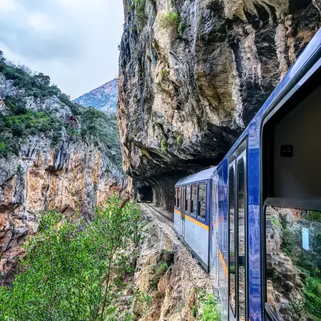 A train cutting through a rocky gorge