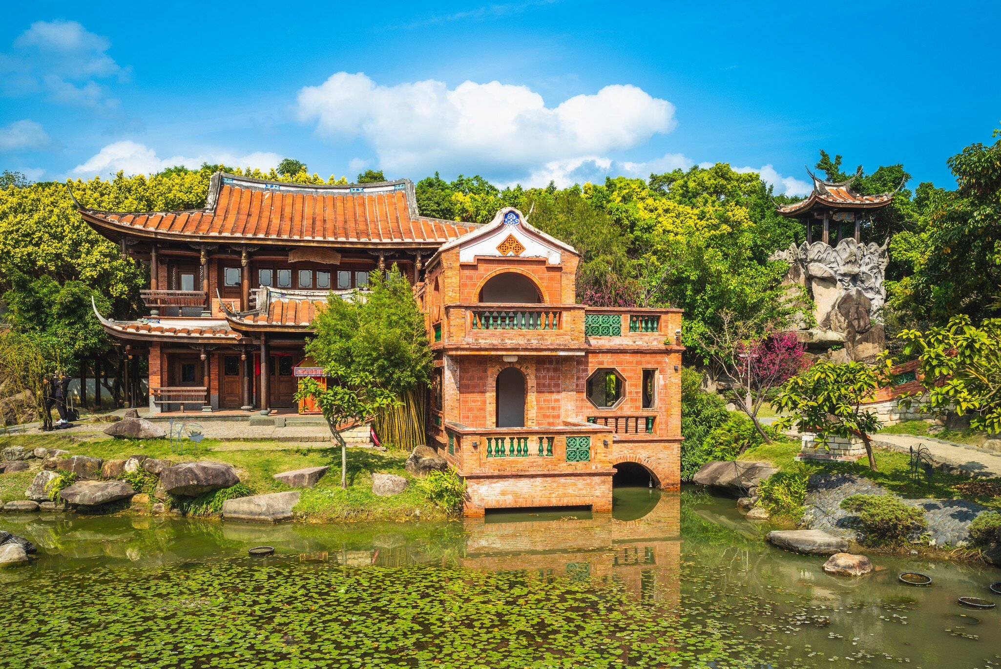 Lin An Tai Historical House and Museum surrounded by a pond and green trees in Taipei, Taiwan.