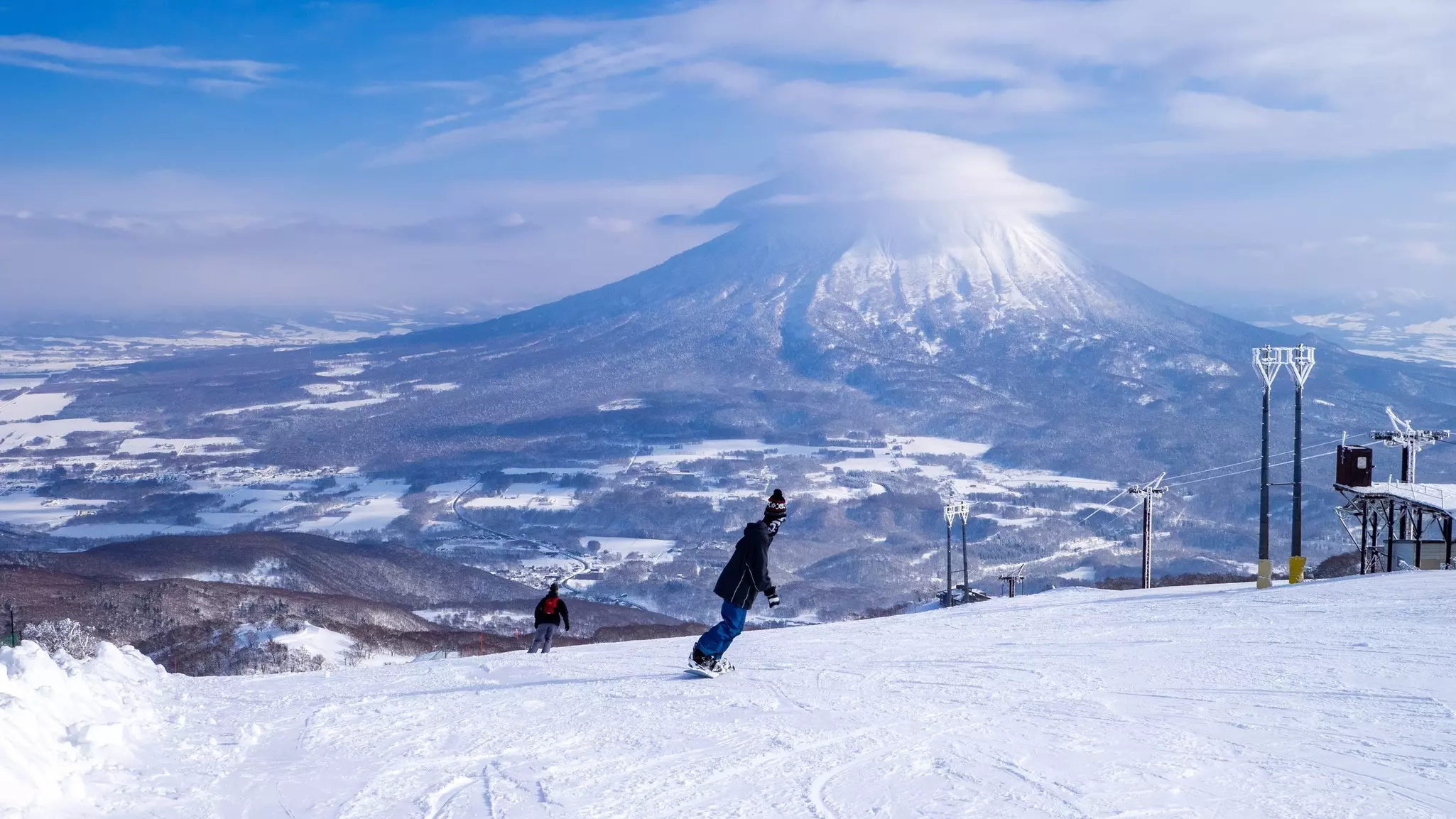 Snowy volcano with cap cloud viewed from a ski resort (Niseko, Hokkaido, Japan)
