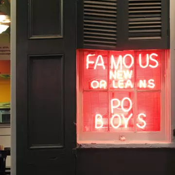 Neon sign advertising po'boy sandwiches in New Orleans, Louisiana. tacojim/Getty Images