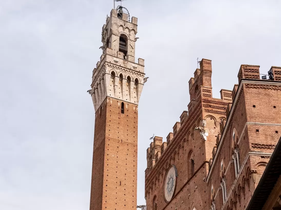 The iconic Palazzo Pubblico at the Piazza del Campo in downtown Siena, Italy.