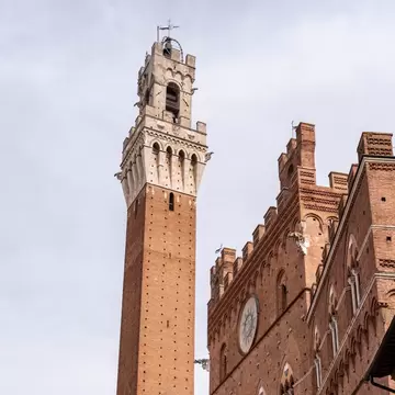 The iconic Palazzo Pubblico at the Piazza del Campo in downtown Siena, Italy.