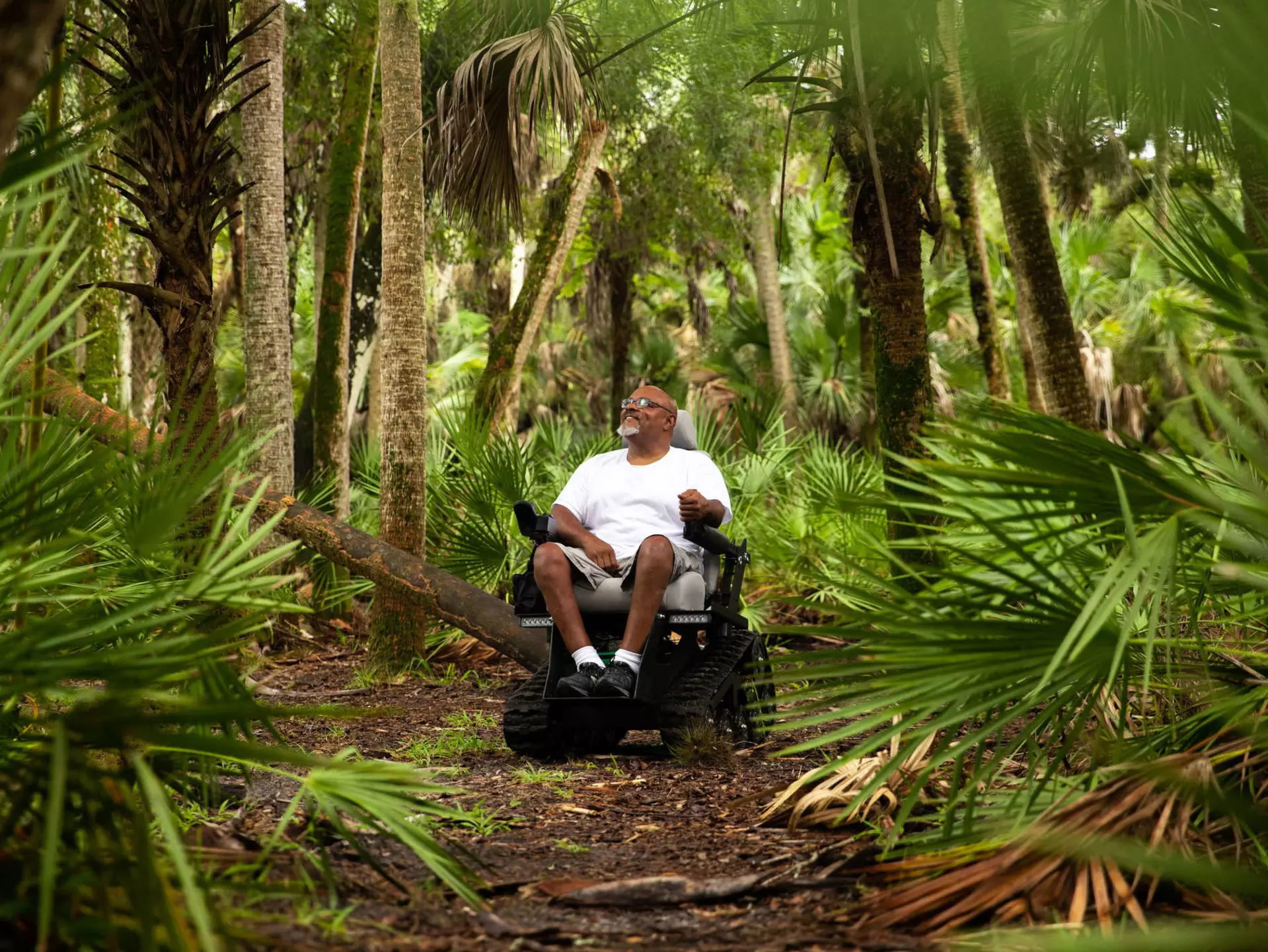 A man in a wheelchair in the woods at Myakka River State Park, Florida