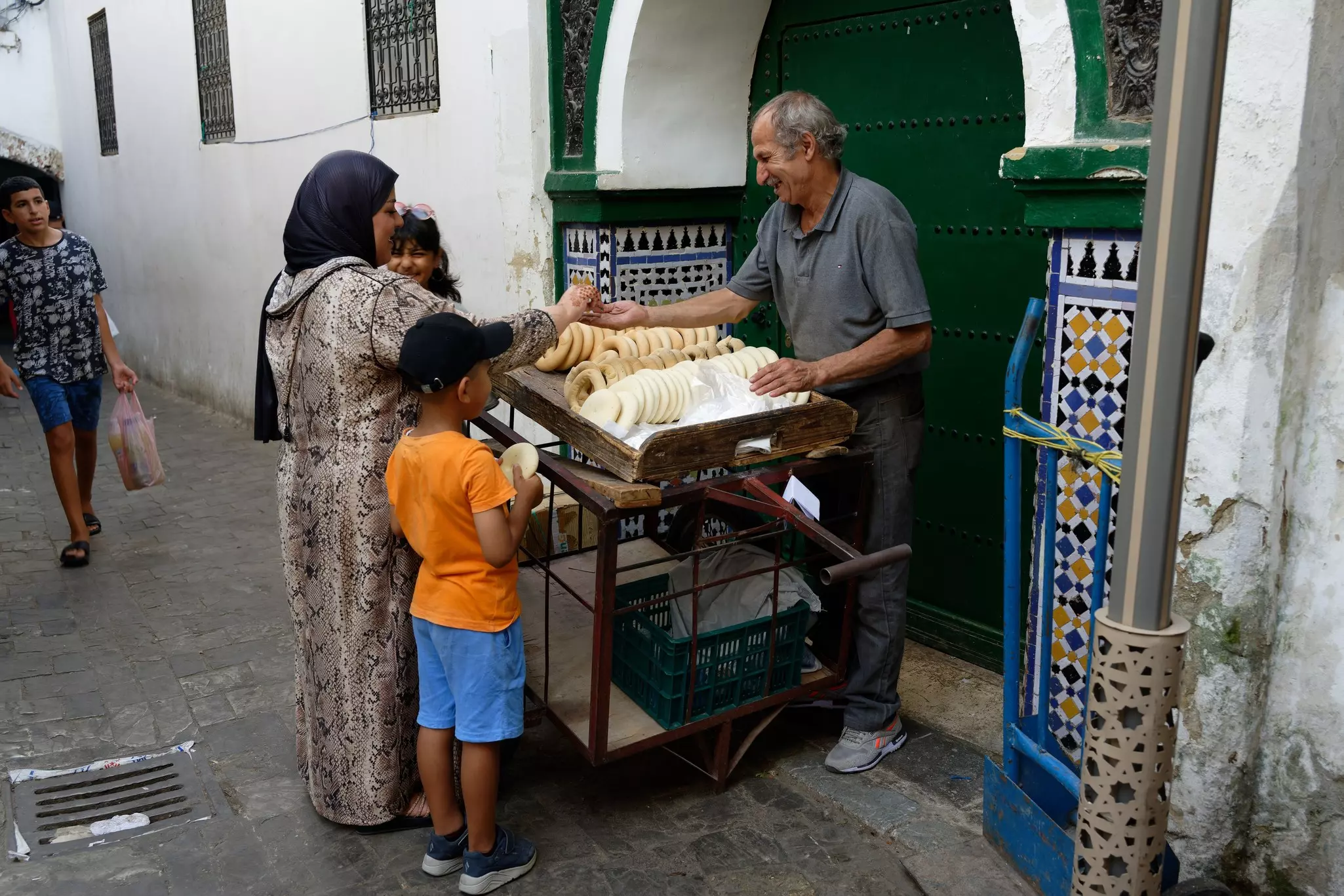 A local woman buying bread in the medina in Tetouan, Morocco. Bruno M Photographie/Shutterstock