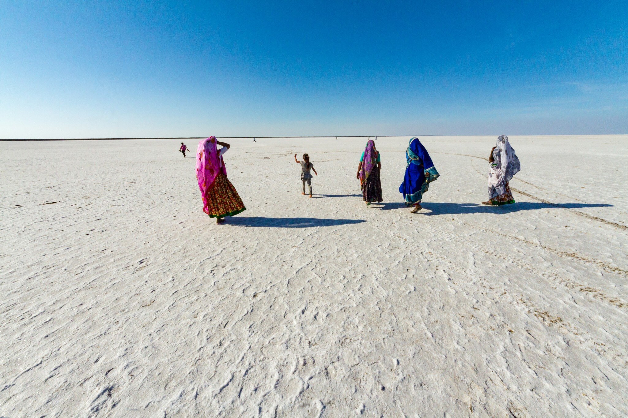 People exploring the salt desert in the Rann of Kachchh (Kutch), Gujarat, India.