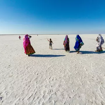 People exploring the salt desert in the Rann of Kachchh (Kutch), Gujarat, India.