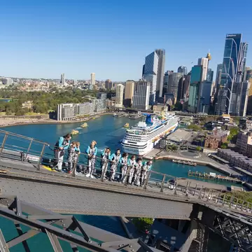 Group of people Climbing the Sydney Harbor Bridge with an Indigenous guide in Sydney, Australia. 