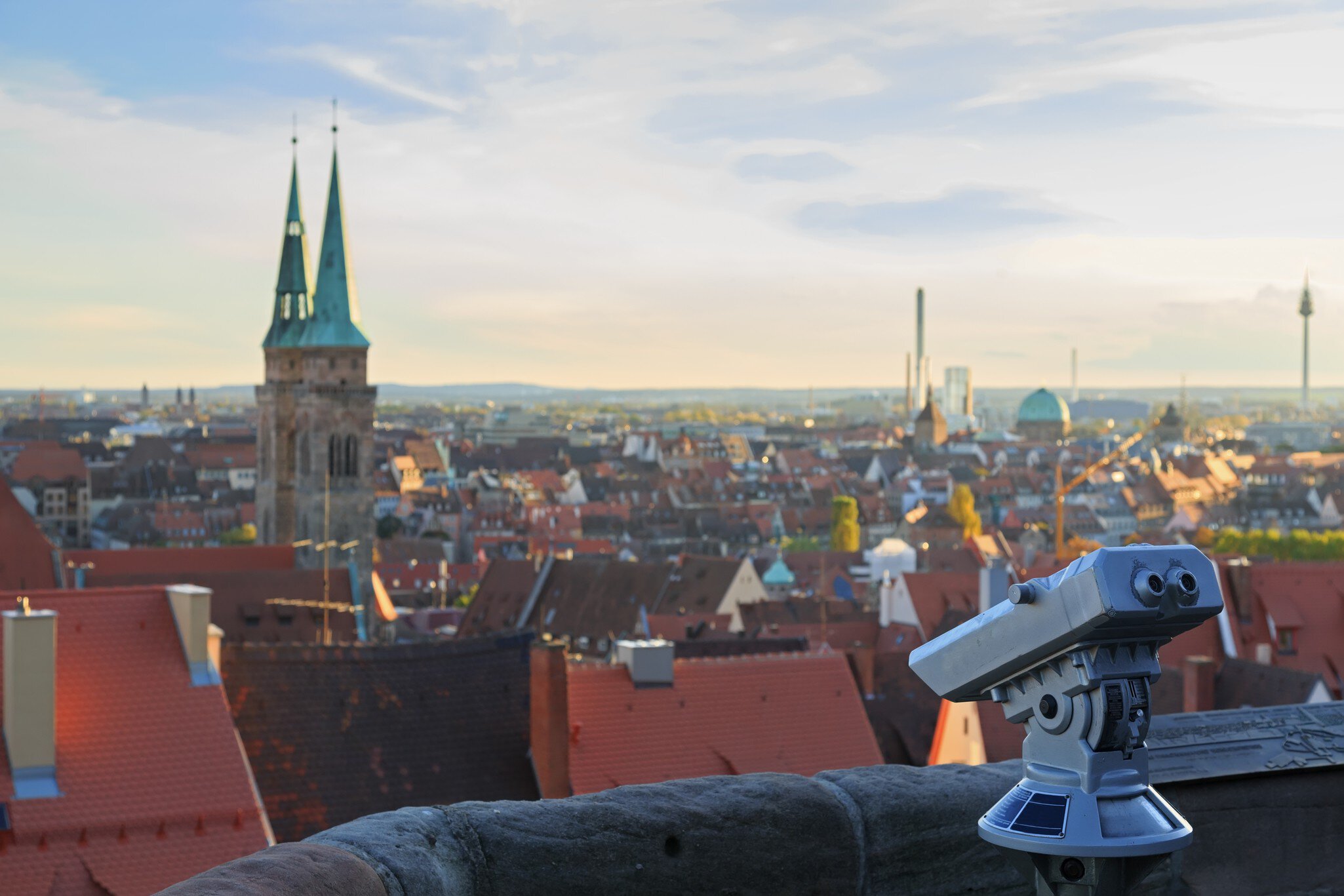 Telescope in Nuremberg castle and cityscape in background.