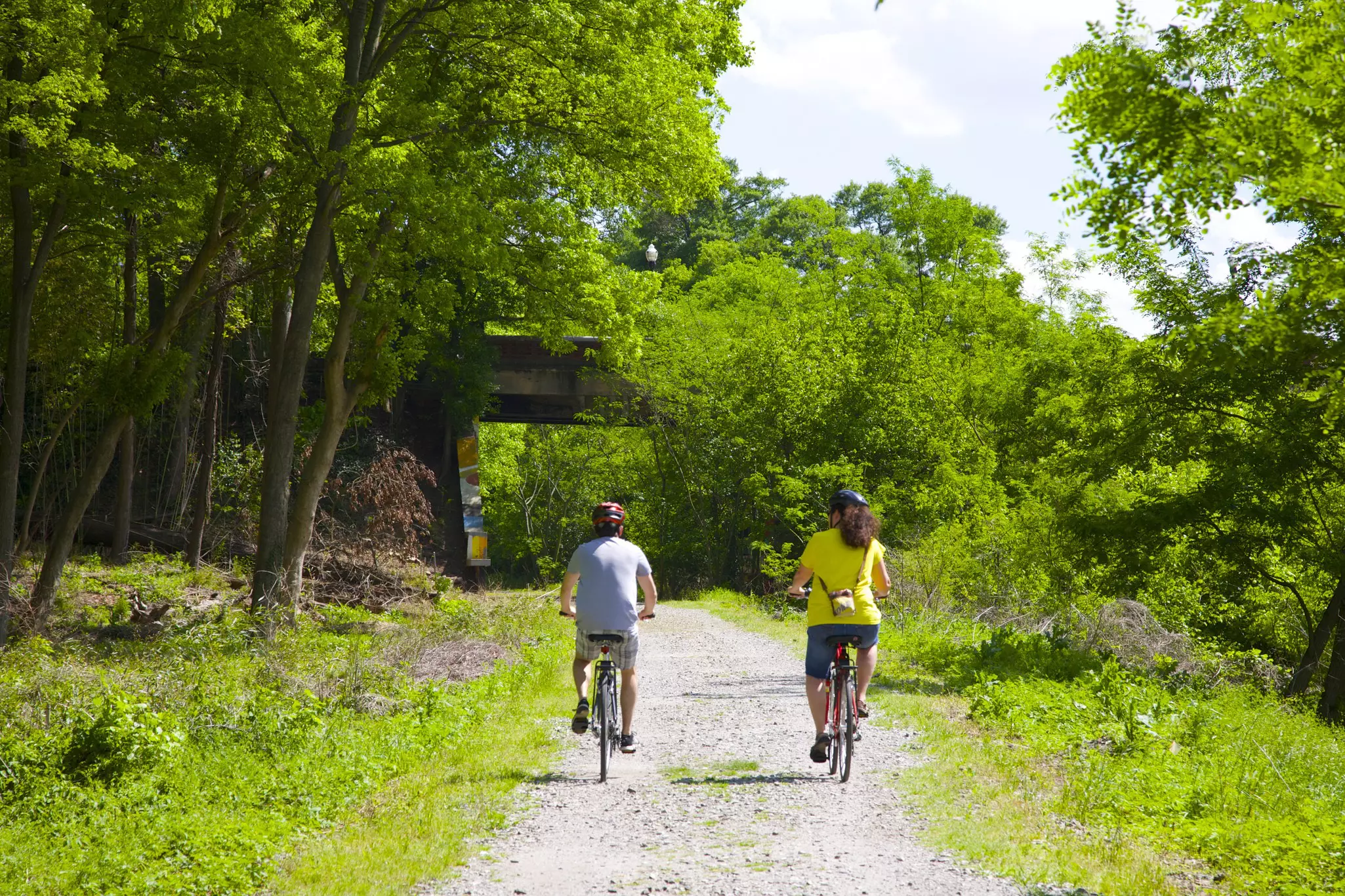 Man and woman riding bicycles in a park on the Atlanta Beltline