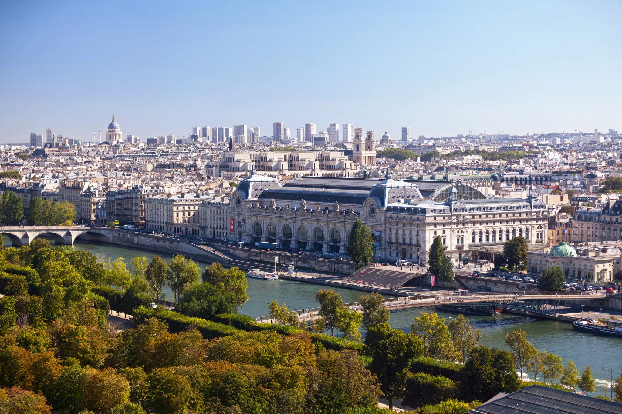 A vast museum building beside a river in a city.