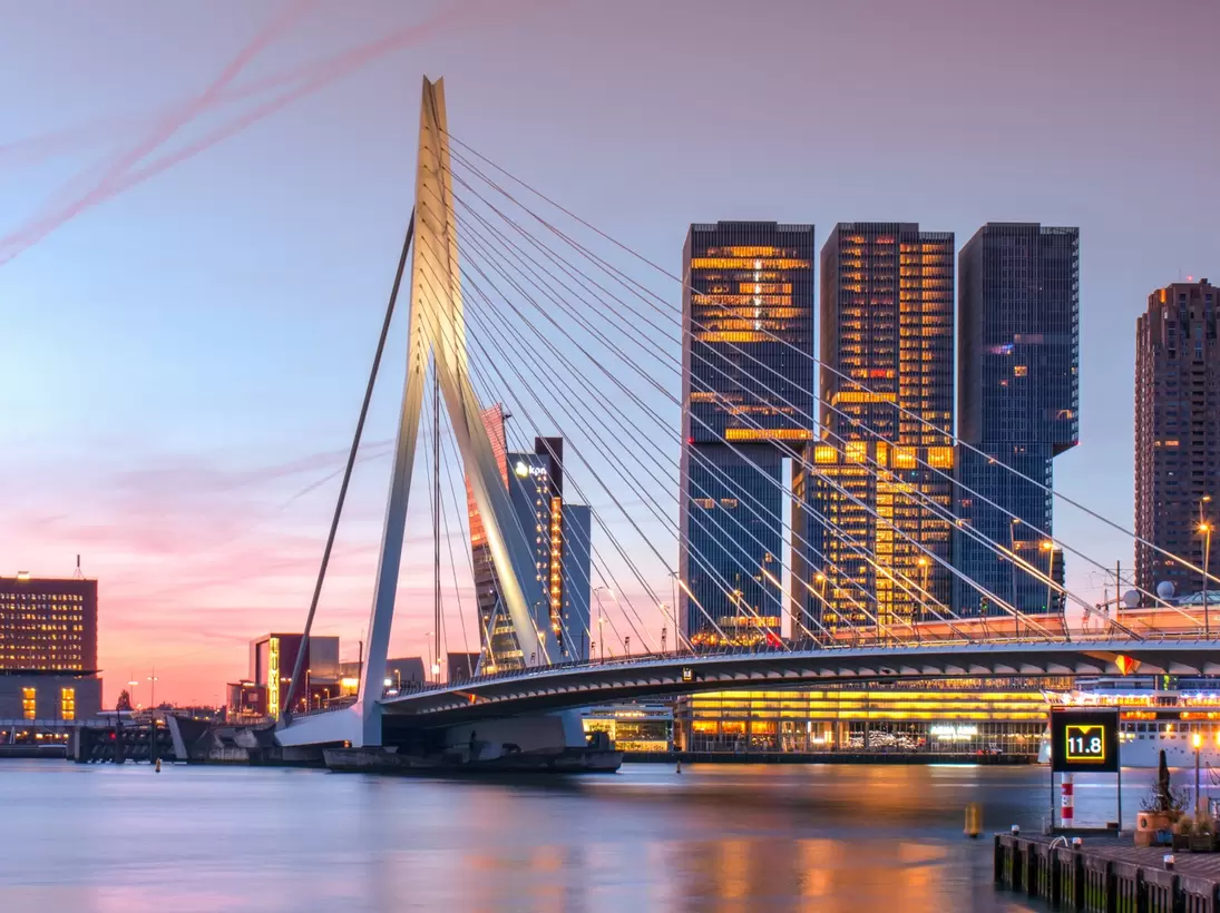 Sunset view of the Erasmus bridge crossing over the river in Rotterdam.