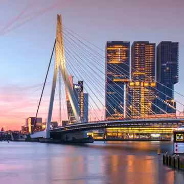 Sunset view of the Erasmus bridge crossing over the river in Rotterdam.