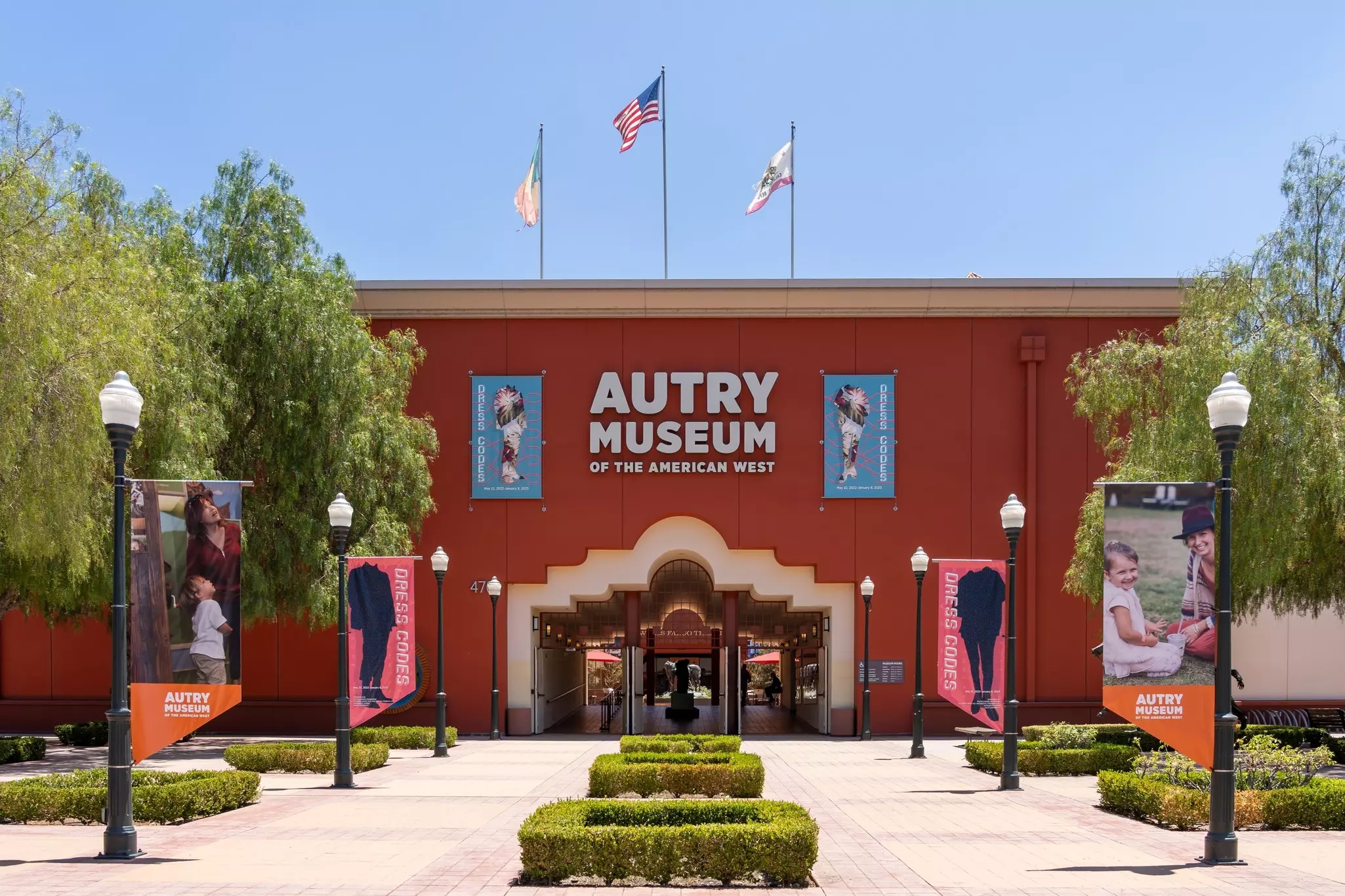 The exterior of a large museum building on a sunny day.
