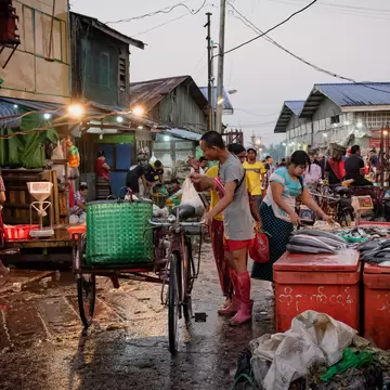 An Alley of Yangon's wholesale fish market. .The market is relatively small but it's a very busy and smelly place. In the early morning, boats from the Irrawaddy unload their catches of the night. Most of the work is done by hand. Boats are unload...