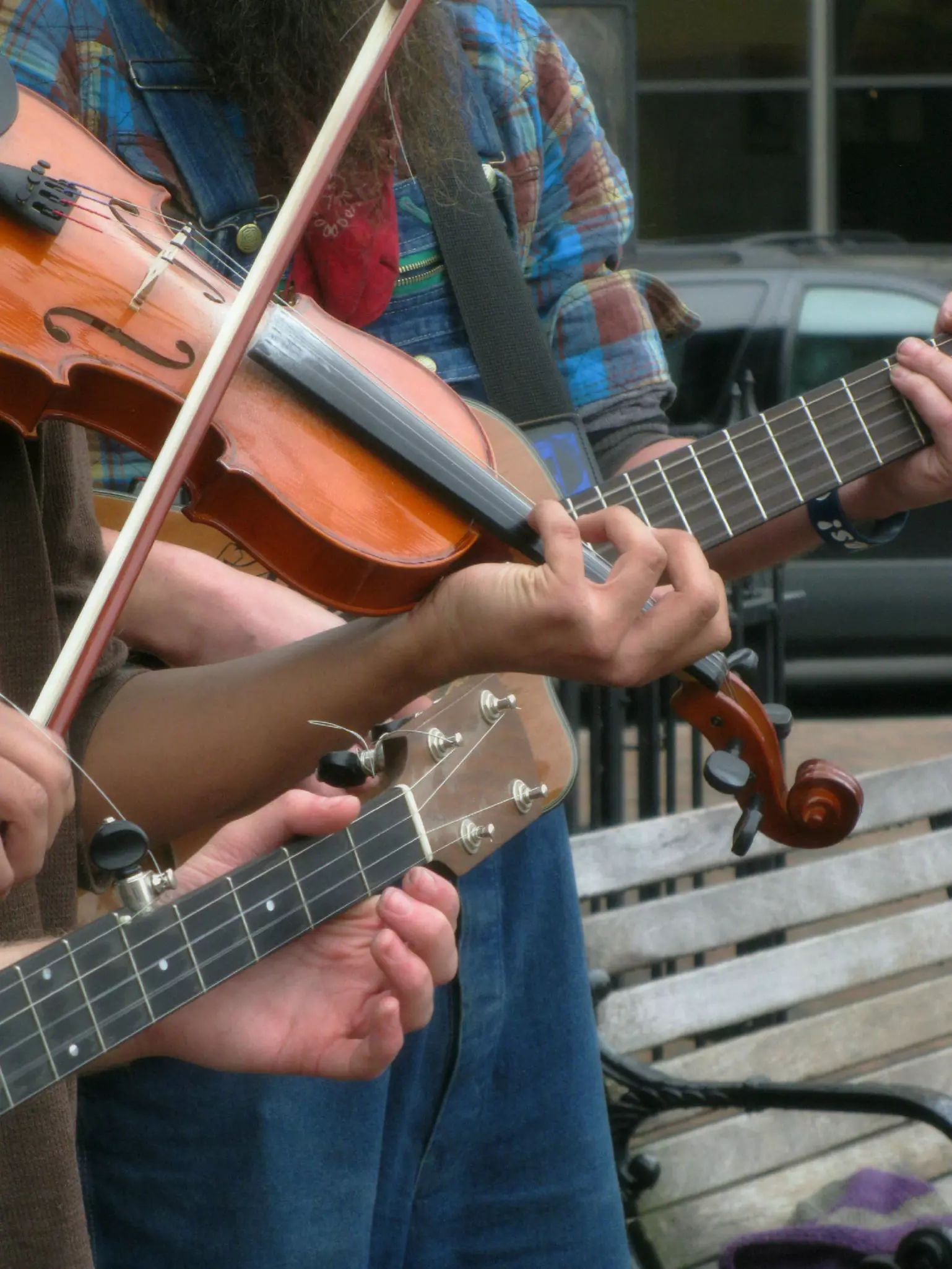 street buskers playing guitars and a fiddle in downtown Asheville