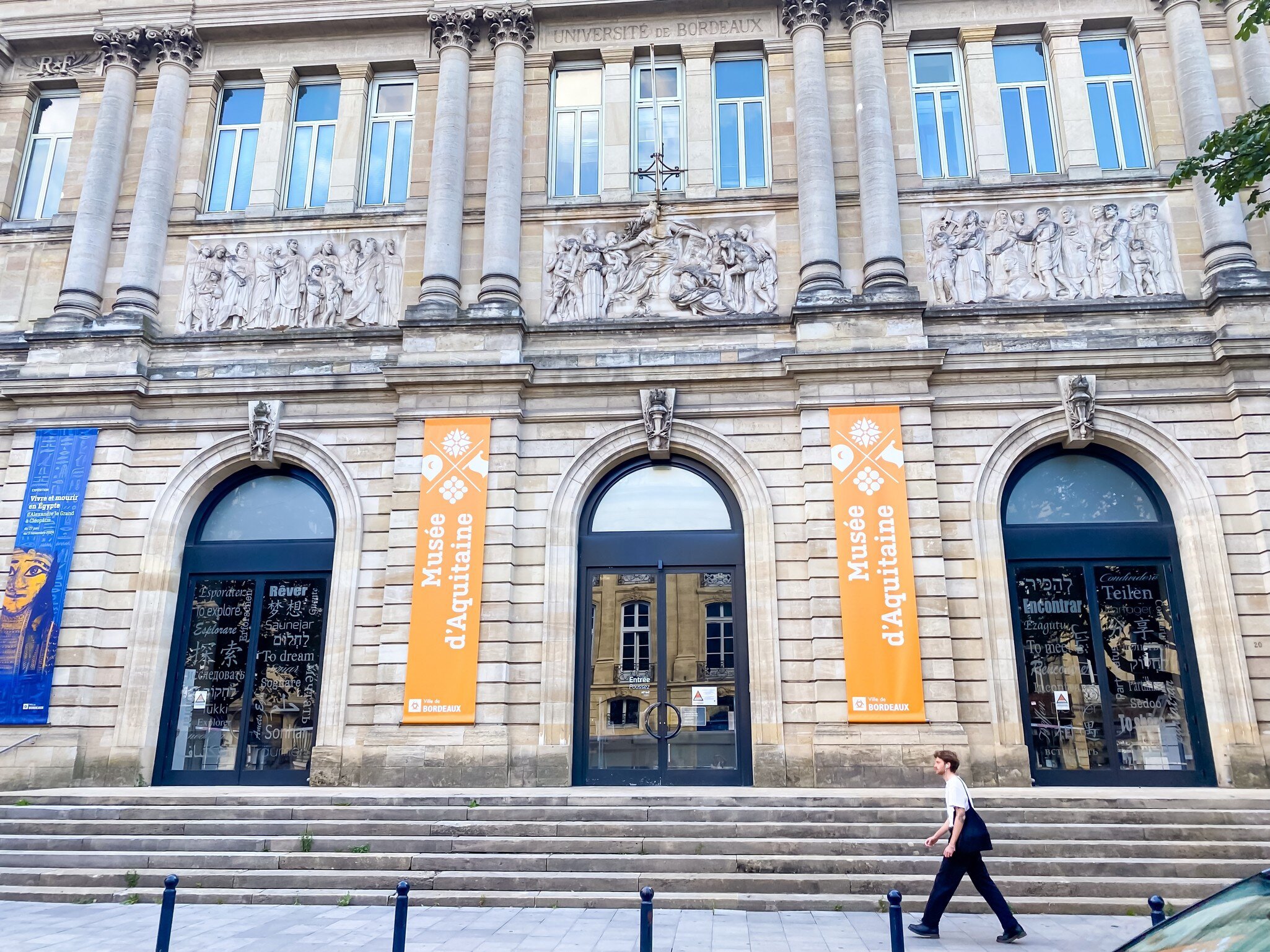 Exterior of the Musée d'Aquitaine museum in Bordeaux, France. Man walking past.