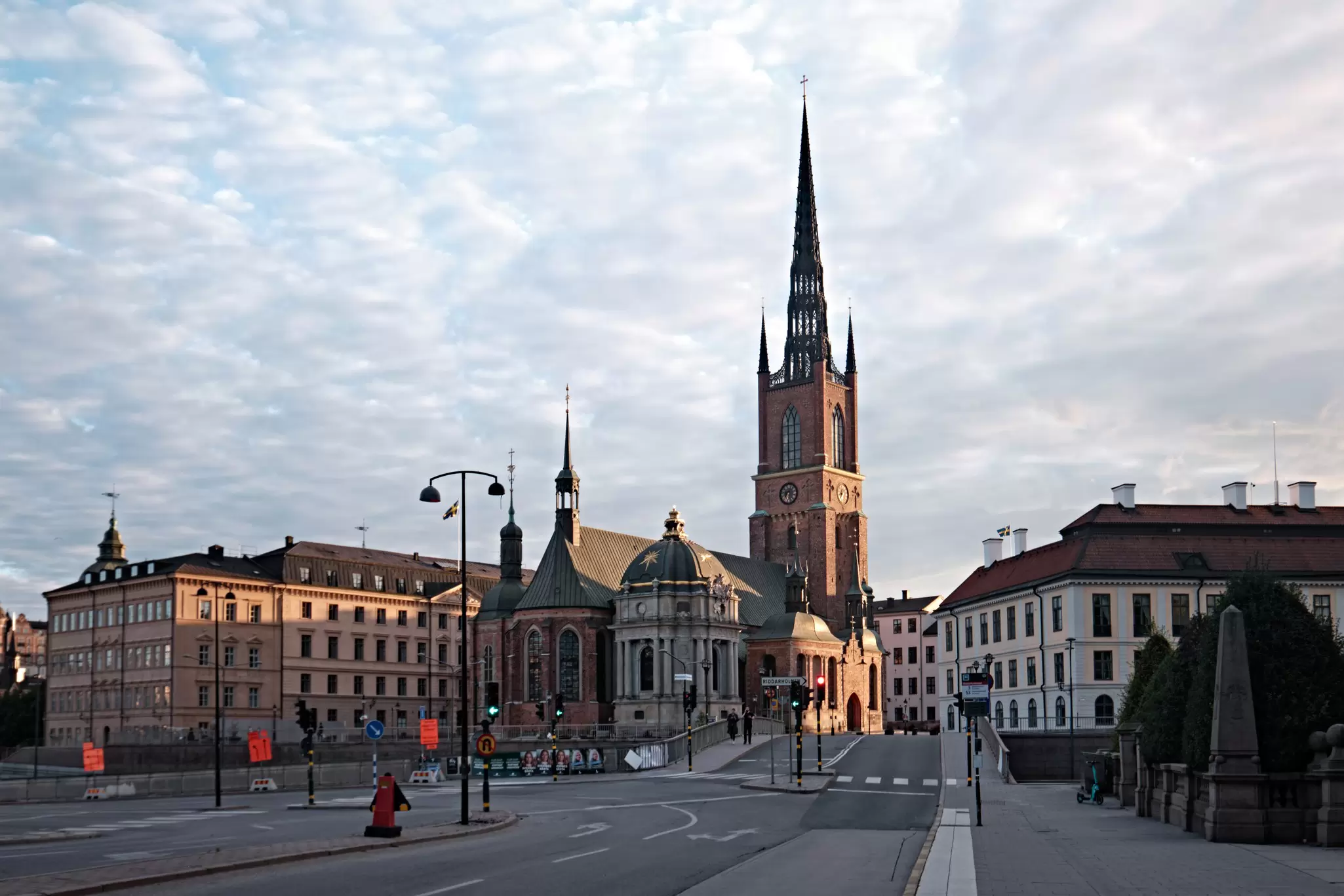 Stockholm, Sweden - Sept 2022: Riddarholmen Church and ornamented spire with scenic street view